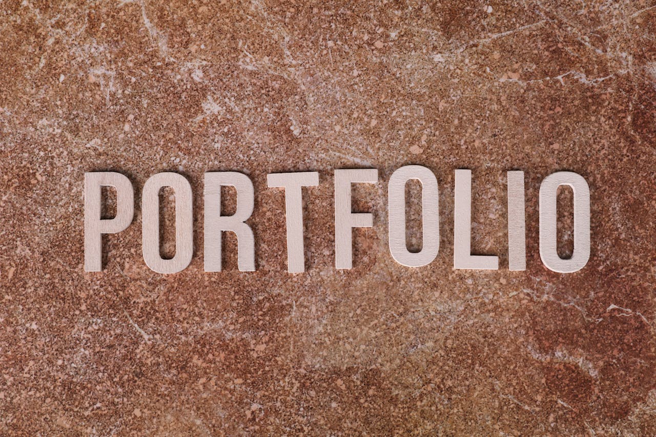 Metallic 'PORTFOLIO' letters on textured brown marble surface. Ideal for presentations.